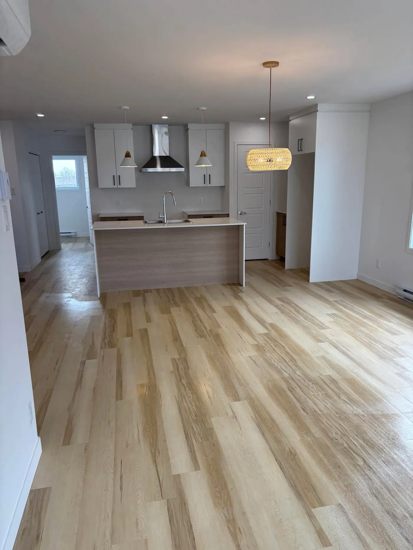 After — Open area cleaned after construction: hardwood floors and windows spotless, ready to move in