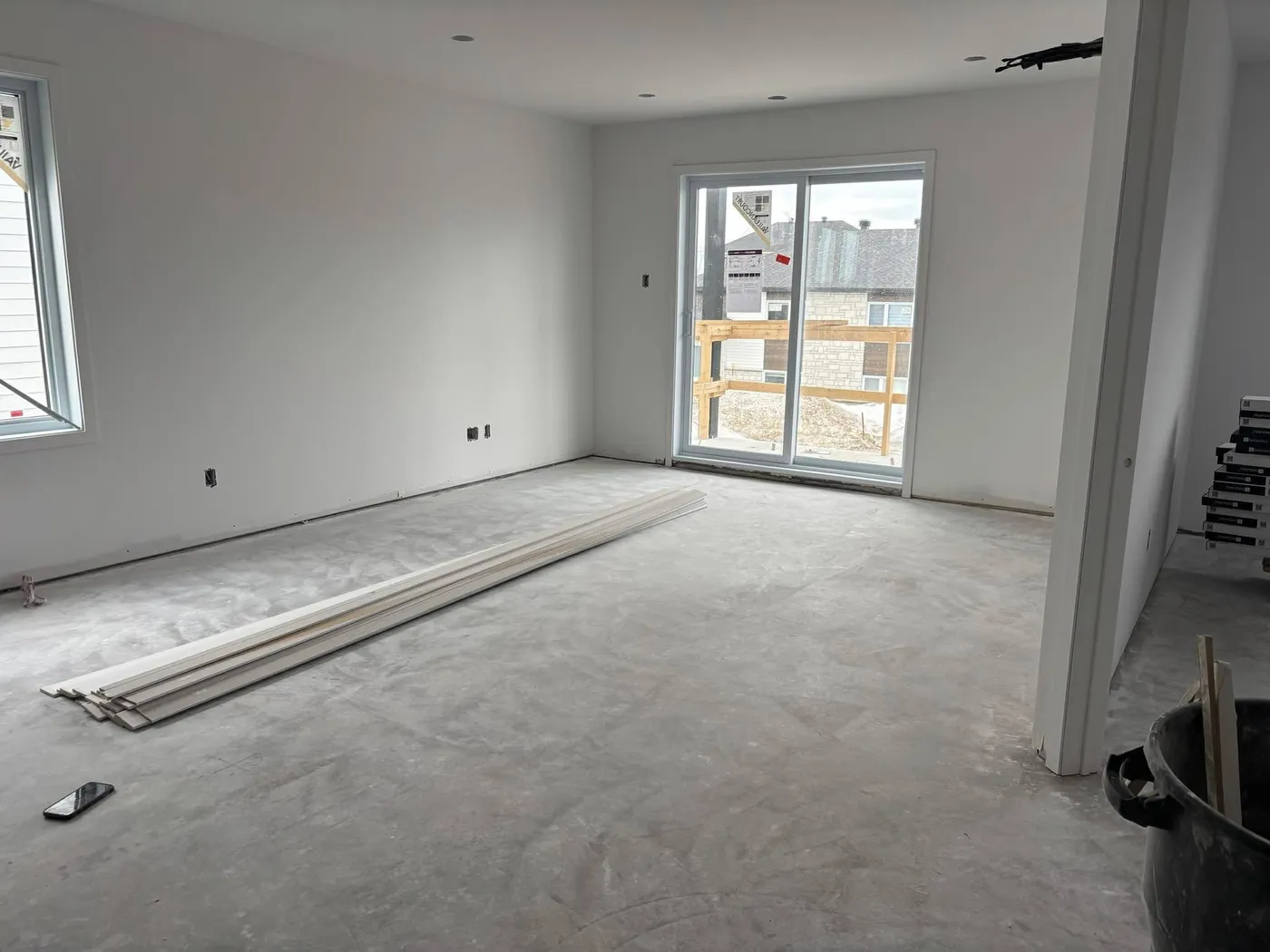 Before — Open area cleaned after construction: hardwood floors and windows spotless, ready to move in