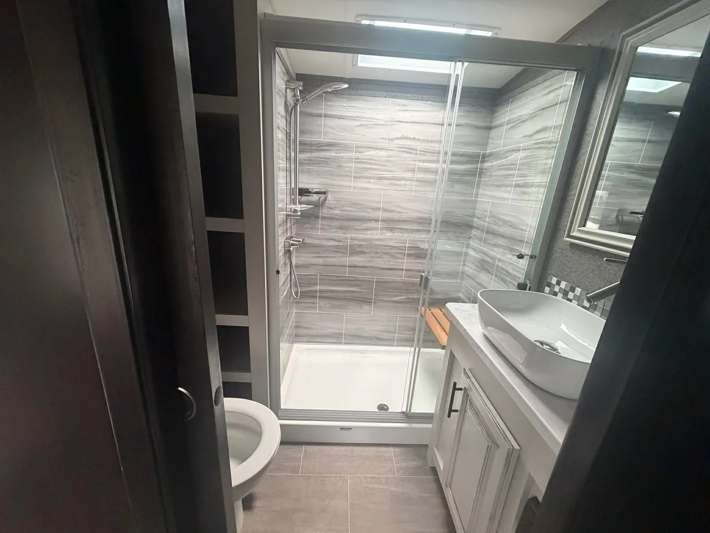 RV bathroom cleaned: ceramic shower and vanity spotless